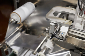 Top view closeup of industrial machine at food packaging department, copy space