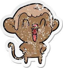 distressed sticker of a cartoon laughing monkey
