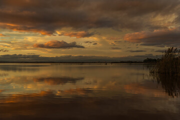 Reflecting yellow-red clouds in Lake Albufera