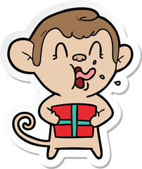 sticker of a crazy cartoon monkey with christmas present