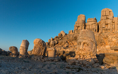sunrise at the heads of ancient statues on East Terrace of Mount Nemrut, Turkey