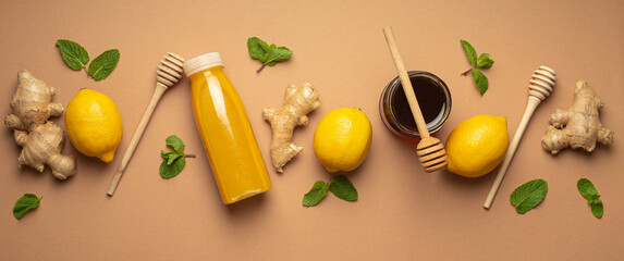 Composition with detox drink, lemons, mint, ginger, honey in glass jar, honey wooden dippers top...