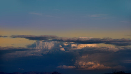 Multicolored sky with gray clouds. Winter weather before the storm. Spring winds scatter the clouds in the blue sky. Peace of nature looking at the sky. 