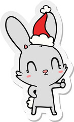 cute hand drawn sticker cartoon of a rabbit wearing santa hat