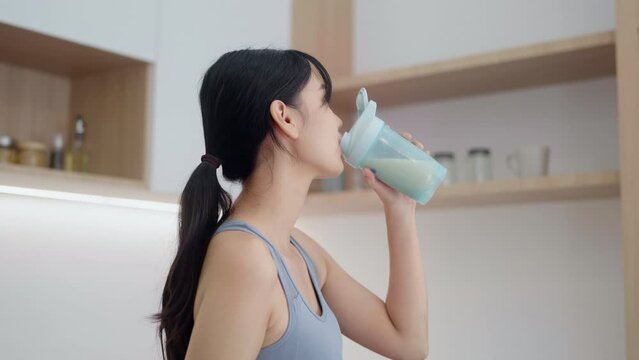 Asian woman drinking whey protein in the morning