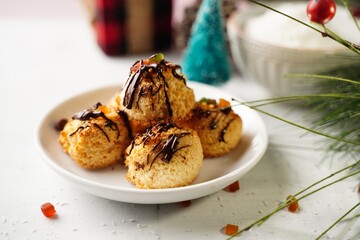 Homemade Coconut macaroons with chocolate drizzle on holiday background, selective focus