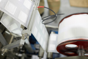 Closeup of production line for coffee drip filters at food factory, copy space