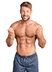 Young caucasian man standing shirtless celebrating surprised and amazed for success with arms raised and open eyes. winner concept.