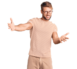 Young caucasian man wearing casual clothes and glasses looking at the camera smiling with open arms for hug. cheerful expression embracing happiness.