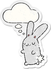 cute cartoon rabbit with thought bubble as a distressed worn sticker