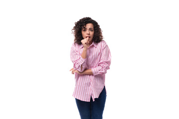 young well-groomed brunette woman in a pink shirt with a grimace isolated on white background