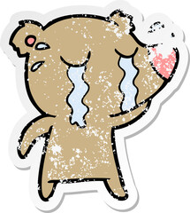 distressed sticker of a cartoon crying bear