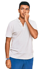 Young arab man wearing casual clothes looking stressed and nervous with hands on mouth biting nails. anxiety problem.
