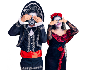 Young couple wearing mexican day of the dead costume over background covering eyes with hands smiling cheerful and funny. blind concept.