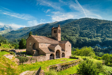 The bell tower of the church of San Miguel is located in the Alto Aragonese town of Linas de Broto, belonging to the municipality of Torla-Ordesa, in the region of Sobrarbe, Aragon. Spain - obrazy, fototapety, plakaty