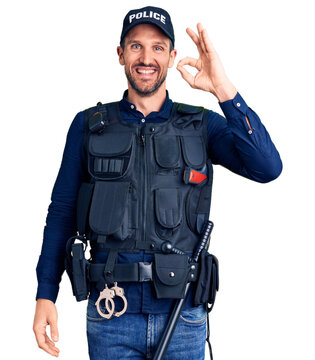 Young handsome man wearing police uniform smiling positive doing ok sign with hand and fingers. successful expression.