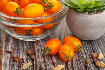 orange plum cherry tomato on wood background