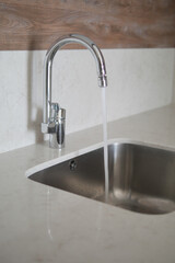 Fototapeta premium water pouring from a faucet tap slow motion 