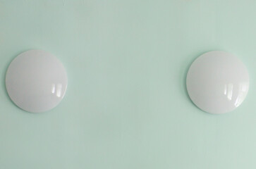 Fragment of a wall with round lamps. Close-up, selective focus.