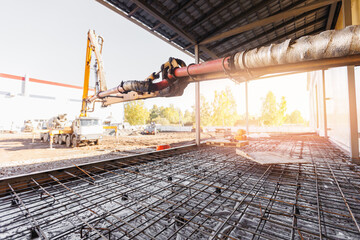 Pipe of Concrete pump working on construction building site, sunlight