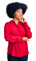 Young african american girl wearing casual clothes with hand on chin thinking about question, pensive expression. smiling and thoughtful face. doubt concept.