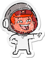 distressed sticker of a cartoon laughing astronaut