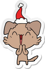 laughing little dog hand drawn sticker cartoon of a wearing santa hat