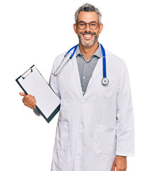 Middle age grey-haired man wearing doctor stethoscope holding clipboard looking positive and happy...