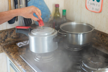 Air coming out of the pressure cooker.