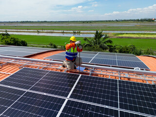 engineer man inspects construction of solar cell panel or photovoltaic cell at roof top. Industrial...