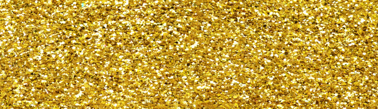 Gold glitter texture sparkling shiny background for Christmas card.  Twinkly golden  glitter lights grunge background.