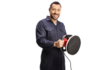 Car service worker holding a polishing machine
