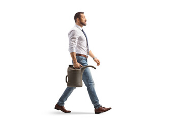 Full length profile shot of a businessman walking with a gas canister