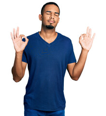 Young african american man wearing casual t shirt relax and smiling with eyes closed doing meditation gesture with fingers. yoga concept.