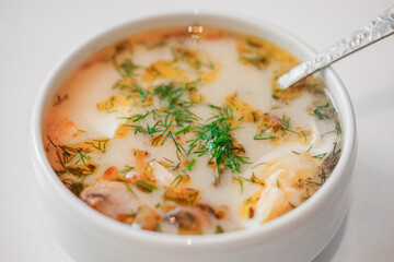 mushroom soup with bill in white bowl, selective focus
