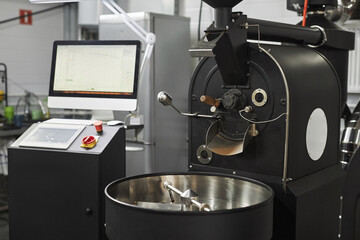 Background of industrial coffee roaster in workshop of food factory, copy space