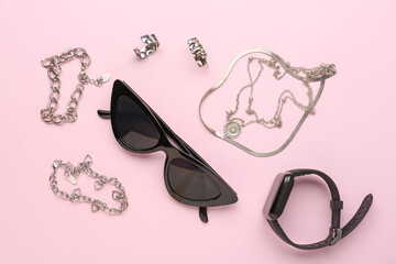 Composition with stylish sunglasses and jewelry on pink background