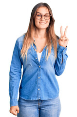 Beautiful caucasian woman wearing casual clothes and glasses with a happy and cool smile on face....