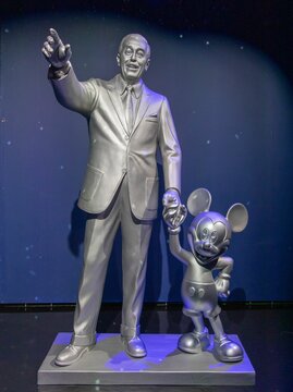 Bronze figurine of Walt with Mickey Mouse at a museum in London, England, UK