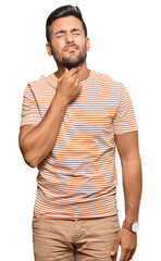 Handsome hispanic man wearing casual clothes touching painful neck, sore throat for flu, clod and infection