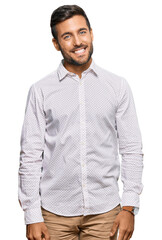 Fototapeta premium Handsome hispanic man wearing business clothes looking positive and happy standing and smiling with a confident smile showing teeth