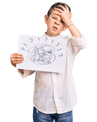 Cute blond kid holding scribble draw stressed and frustrated with hand on head, surprised and angry...