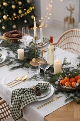 Christmas table setting with festive decor and dishware indoors