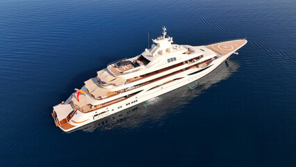 Aerial drone top down photo of luxury yacht with wooden deck anchored in paradise exotic deep blue sea island bay © aerial-drone