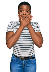 Young african american woman wearing casual clothes shocked covering mouth with hands for mistake. secret concept.