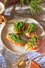 sandwich with salmon, arugula and cream cheese. Wooden background, top view