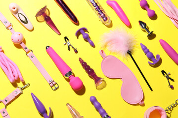 Different sex toys on yellow background