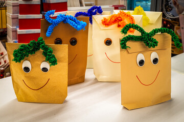 Magdeburg, Germany-12-01-2023: Paper bags with colorful faces are on the table in a shop