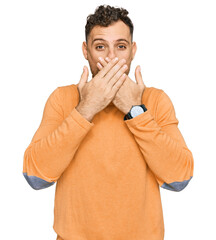 Young hispanic man wearing casual clothes shocked covering mouth with hands for mistake. secret concept.