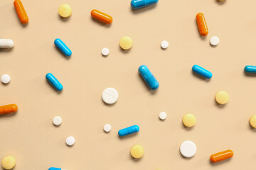 Many different pills on orange background